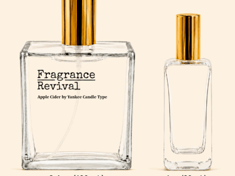 Fragrance Revival Apple Cider perfume bottles with gold caps on a beige background; printed 3.4 oz bottle shown with 1 oz plain bottle nearby.